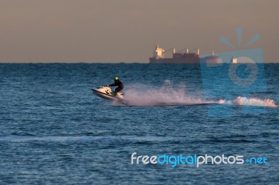 Man Riding A Jet Ski Off Dungeness Beach Stock Photo