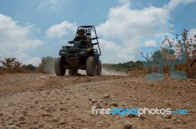 Man Riding Quad Bike Stock Photo