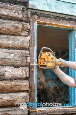 Man Sawing A Window Stock Photo