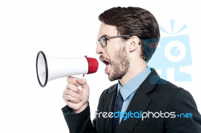 Man Screaming With Anger Over Loudhailer Stock Photo