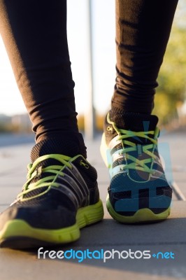 Man Shoes Running On The Asphalt With The Sky In The Background Stock Photo