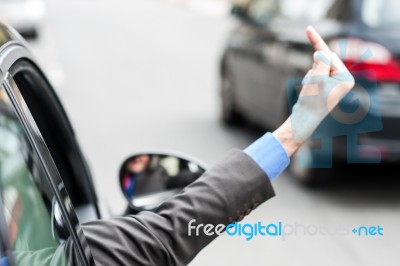 Man Showing Middle Finger From Car Window Stock Photo