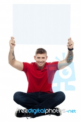 Man Sitting On Floor With Board Stock Photo