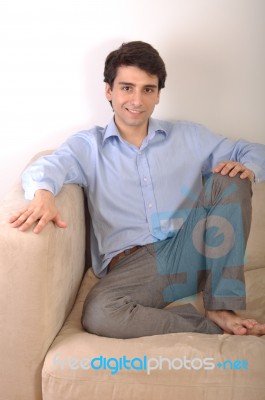 Man Sitting On The Couch Stock Photo