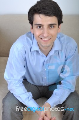 Man Sitting On The Couch Stock Photo