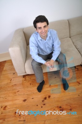 Man Sitting On The Couch Stock Photo