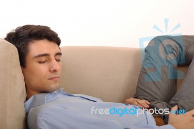 Man Sleeping On The Couch Stock Photo