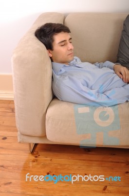 Man Sleeping On The Couch Stock Photo