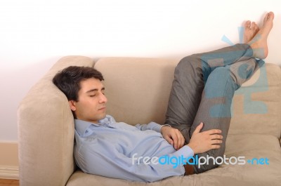 Man Sleeping On The Couch Stock Photo