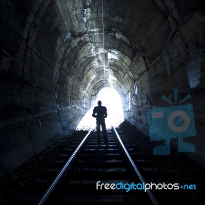 Man Standing In Train Tunnel Stock Photo