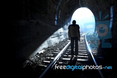 Man Standing In Train Tunnel Stock Photo