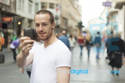 Man Taking Photo With Mobile Phone Stock Photo