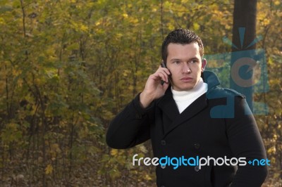 Man Talking On The Phone In The Park Stock Photo