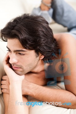 Man Thinking By Laying On Sofa Stock Photo