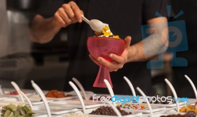 Man Topping Ice-cream With Gems And Jellies Stock Photo