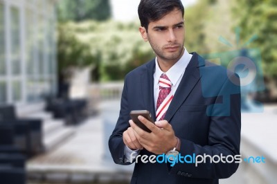 Man Using A Smart Phone On The Street Stock Photo