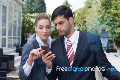 Man Using A Smart Phone On The Street Stock Photo