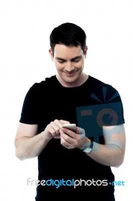 Man Using Mobile To Send Text Message Stock Photo