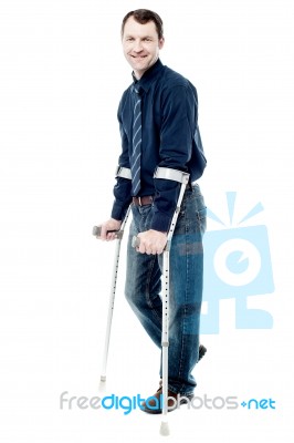 Man Walking With Crutches Isolated On White Stock Photo