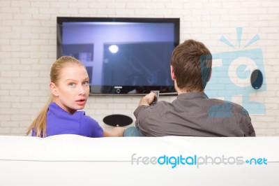 Man Watching Tv Woman Looking Back Stock Photo