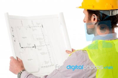 Man Wearing Hard Hat Reviewing The Plan Stock Photo