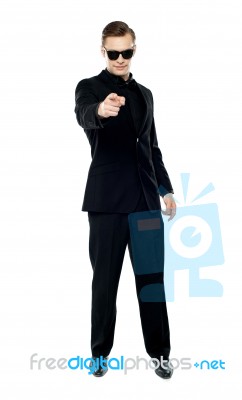 Man Wearing Sunglasses And Pointing Stock Photo