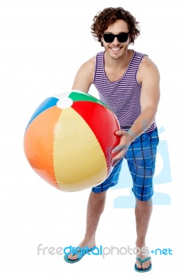 Man With A Colorful Big Beach Ball Stock Photo