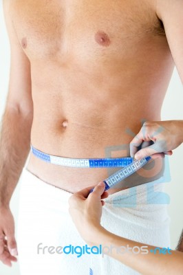 Man With A Helthy Body Measuring His Stomach. Diet Concept Stock Photo