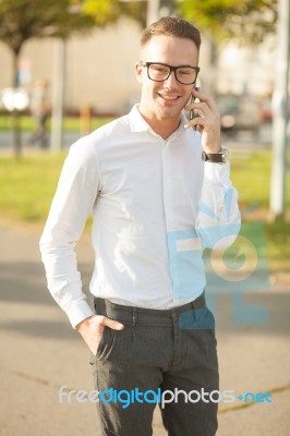 Man With Glasses Speak On Mobile Phone In Hands Stock Photo