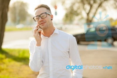 Man With Glasses Speak On Mobile Phone In Hands Stock Photo