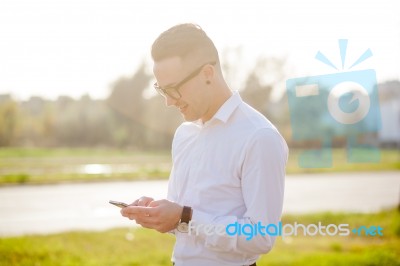 Man With Glasses Speak On Mobile Phone In Hands Stock Photo