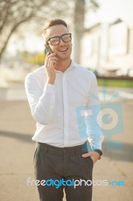 Man With Glasses Speak On Mobile Phone In Hands Stock Photo