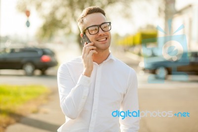 Man With Glasses Speak On Mobile Phone In Hands Stock Photo