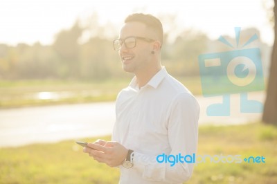 Man With Glasses Speak On Mobile Phone In Hands Stock Photo