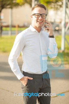 Man With Glasses Speak On Mobile Phone In Hands Stock Photo