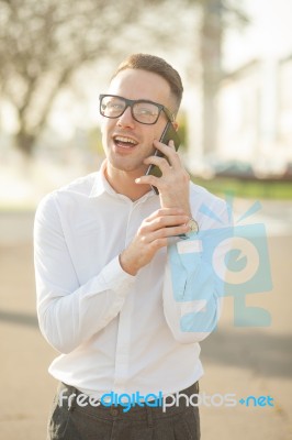 Man With Glasses Speak On Mobile Phone In Hands Stock Photo