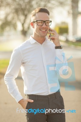 Man With Glasses Speak On Mobile Phone In Hands Stock Photo