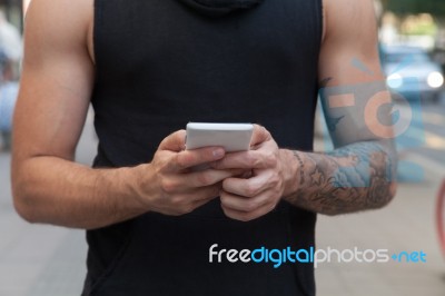 Man With Mobile Phone In Hands Stock Photo