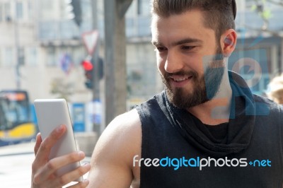 Man With Mobile Phone In Hands Stock Photo