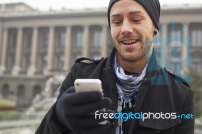 Man With Mobile Phone In Hands Stock Photo