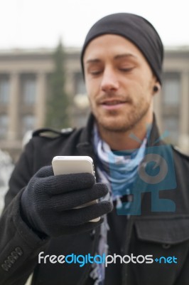 Man With Mobile Phone In Hands Stock Photo