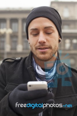 Man With Mobile Phone In Hands Stock Photo