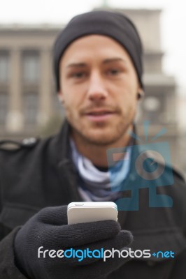 Man With Mobile Phone In Hands Stock Photo