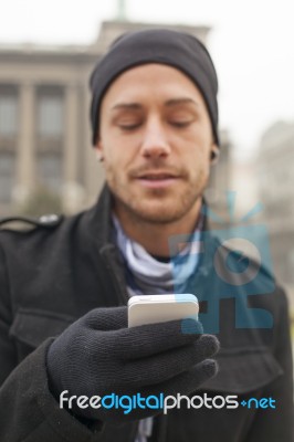 Man With Mobile Phone In Hands Stock Photo