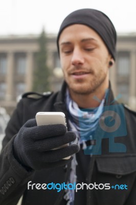 Man With Mobile Phone In Hands Stock Photo