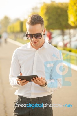 Man With Mobile Phone In Hands Stock Photo