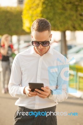 Man With Mobile Phone In Hands Stock Photo