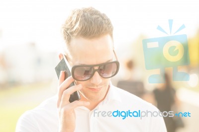 Man With Mobile Phone In Hands Stock Photo