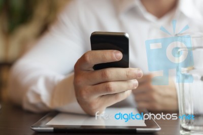 Man With Smartphone And Tablet Computer In Restaurant Stock Photo