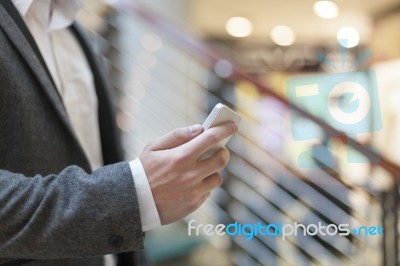 Man With Smartphone In Business Building Stock Photo